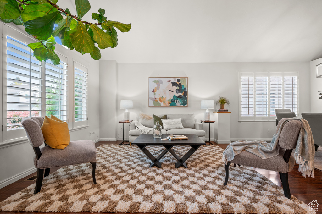 Living room with wood finished floors, healthy amount of natural light, and baseboards