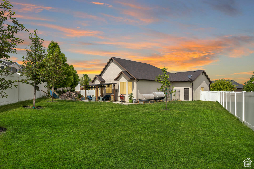 Back of house at dusk with stucco siding