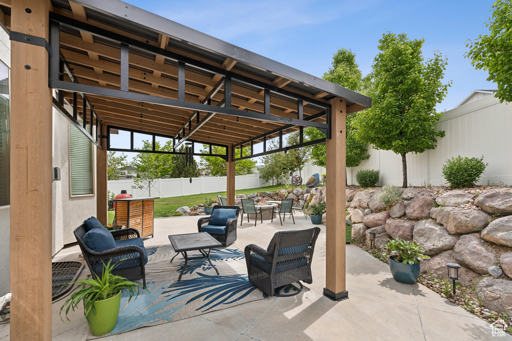 View of patio featuring an outdoor hangout area and a fenced backyard