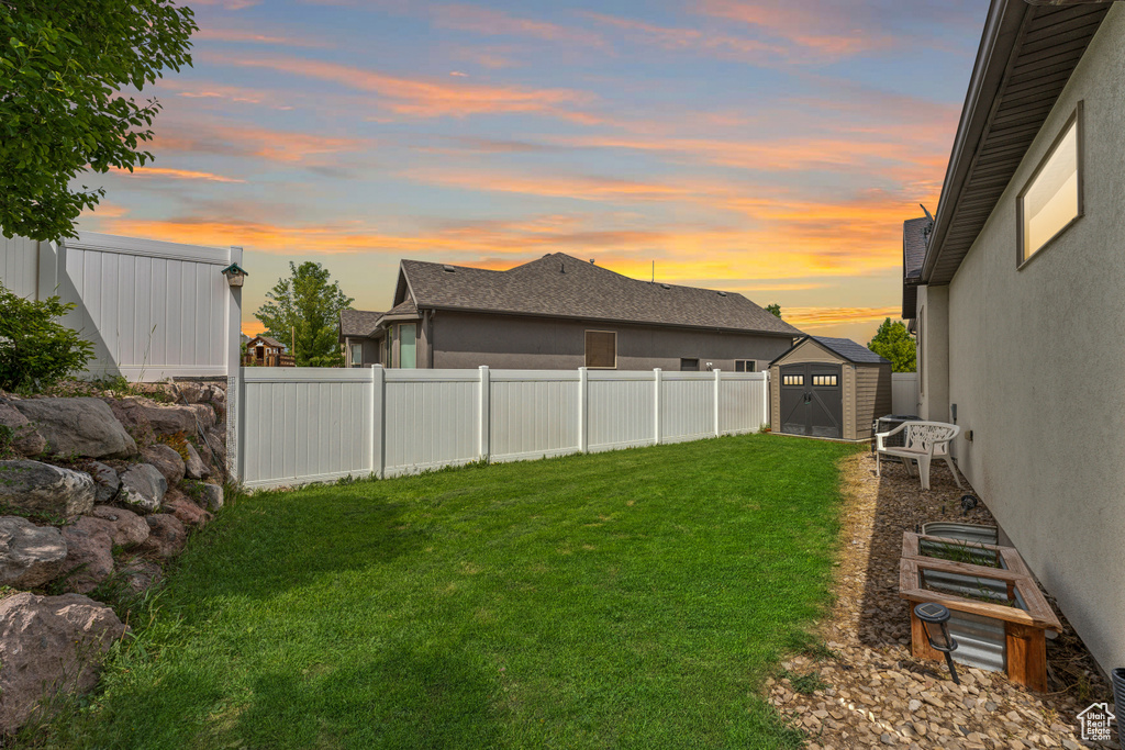 View of yard featuring a shed and an outdoor structure