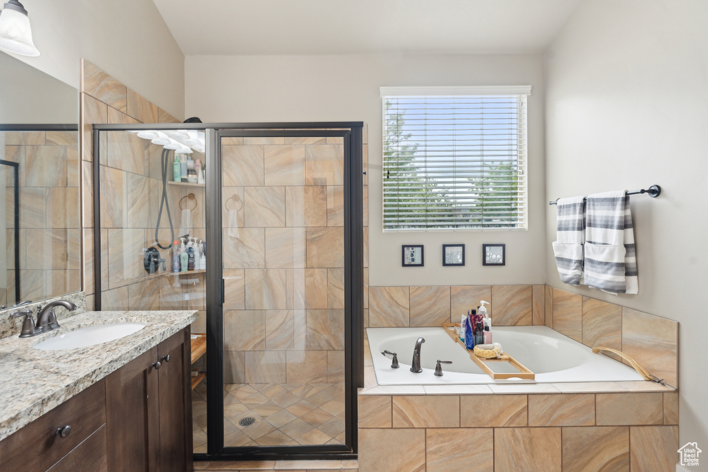 Full bathroom with a bath, a shower stall, and vanity
