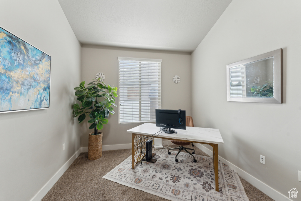 Carpeted office space with baseboards