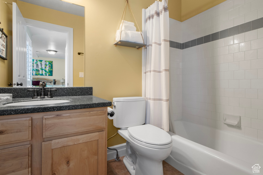 Full bathroom with vanity, toilet, and shower / bathtub combination with curtain