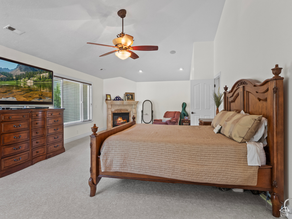 Bedroom with carpet, visible vents, recessed lighting, ceiling fan, and a glass covered fireplace