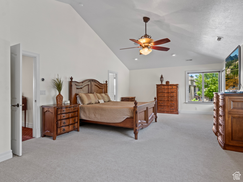Bedroom featuring light colored carpet, baseboards, high vaulted ceiling, and a ceiling fan
