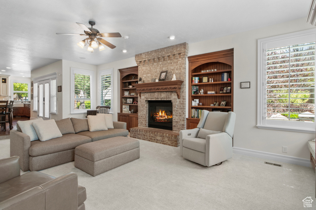 Living room featuring recessed lighting, baseboards, ceiling fan, visible vents, and a fireplace