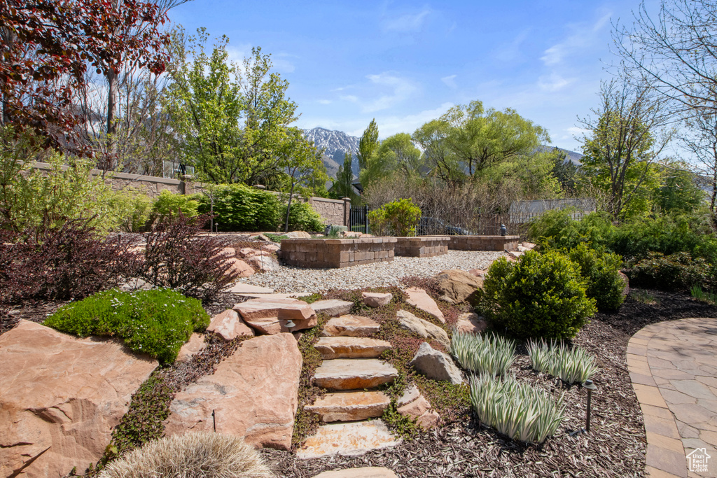 View of yard featuring a mountain view and fence
