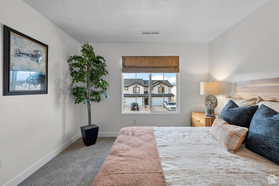 Carpeted bedroom with baseboards