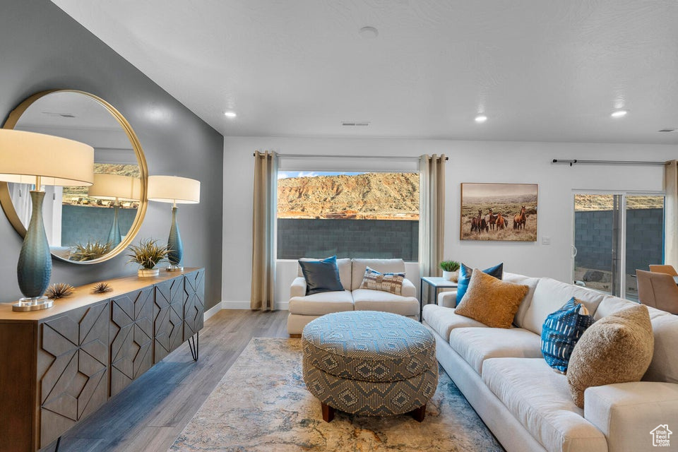 Living room featuring wood finished floors, recessed lighting, and baseboards