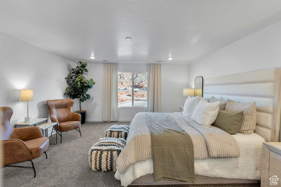 Carpeted bedroom with baseboards and recessed lighting