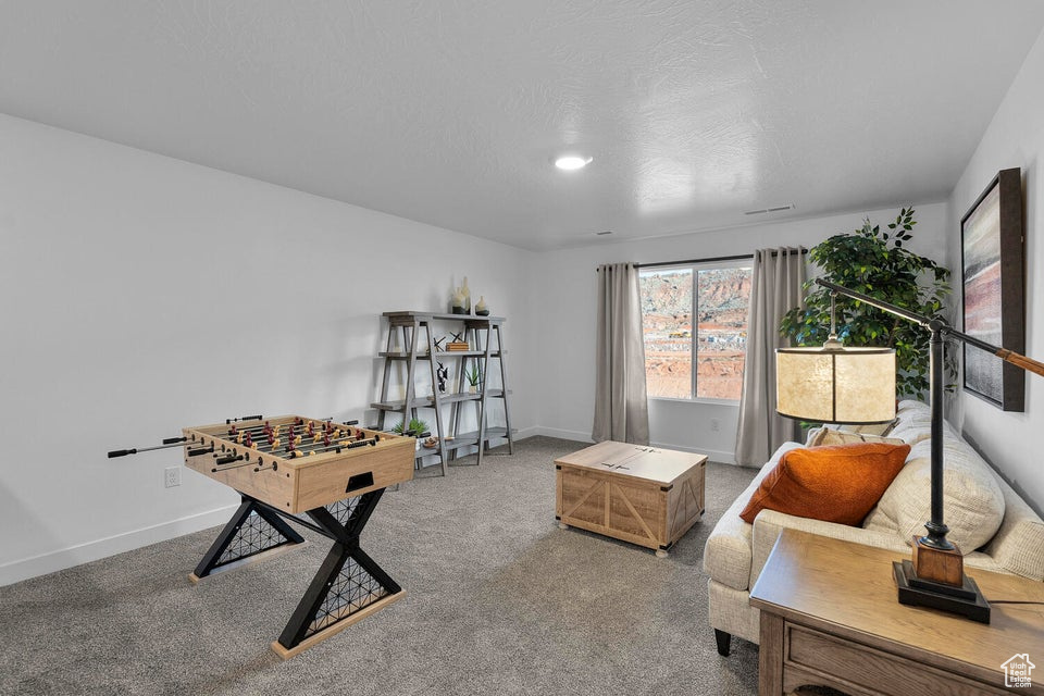 Rec room with carpet floors and baseboards
