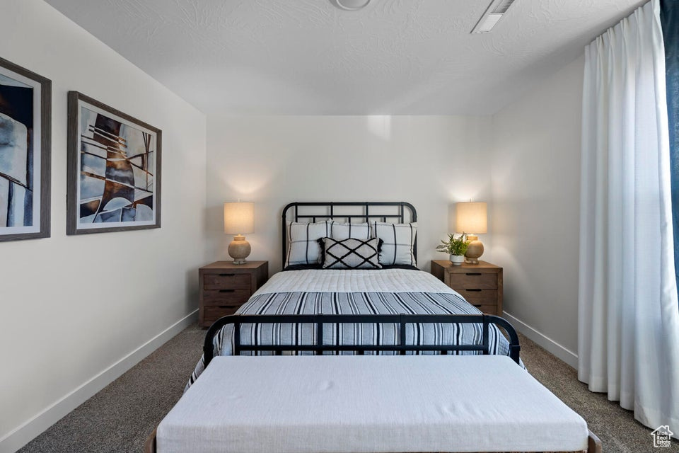 Carpeted bedroom with baseboards