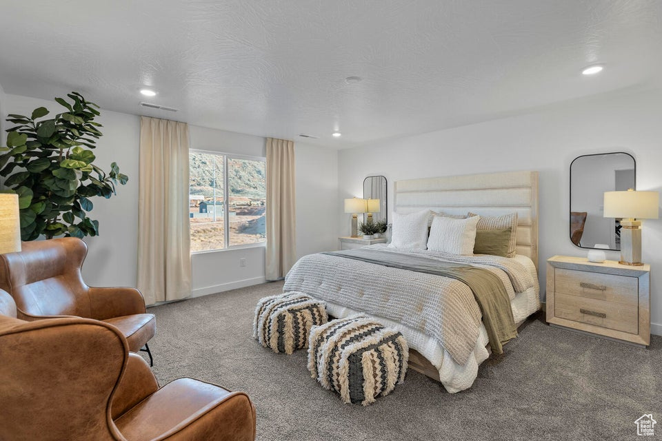 Carpeted bedroom with baseboards and recessed lighting