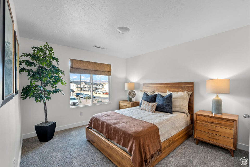 Bedroom with carpet flooring and baseboards