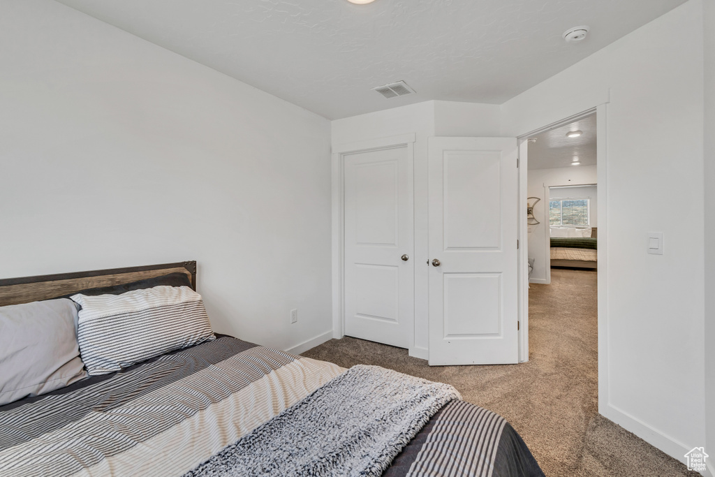 Carpeted bedroom featuring baseboards