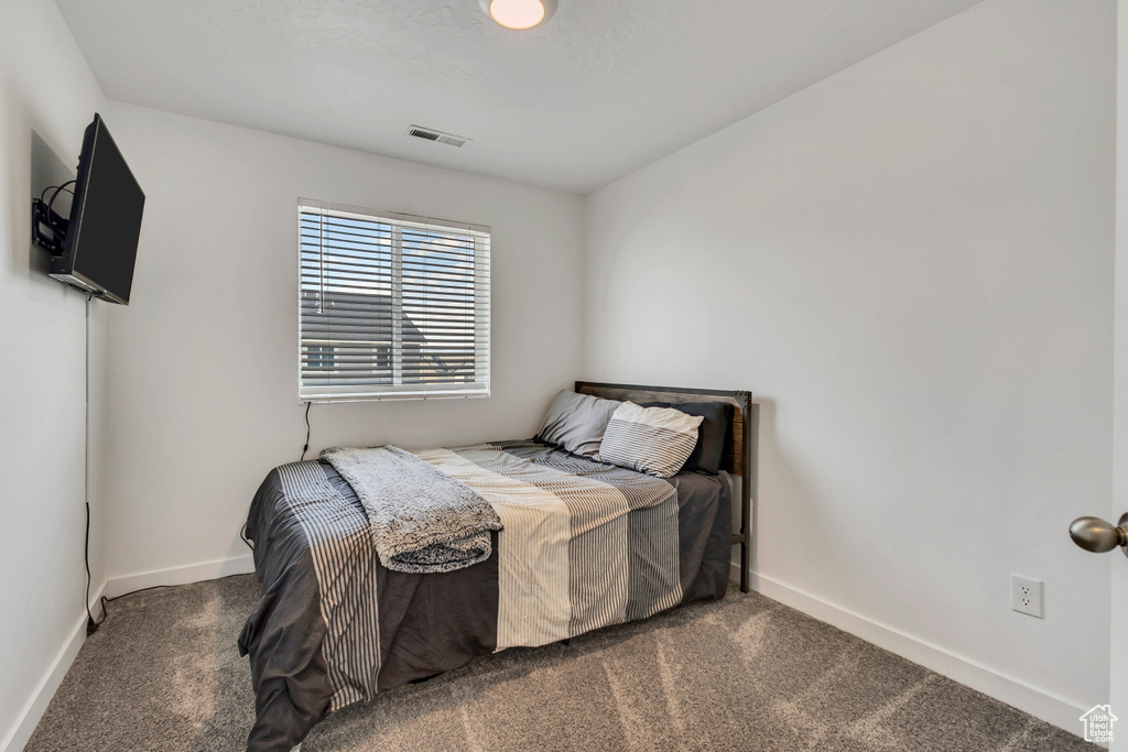Bedroom with carpet flooring and baseboards