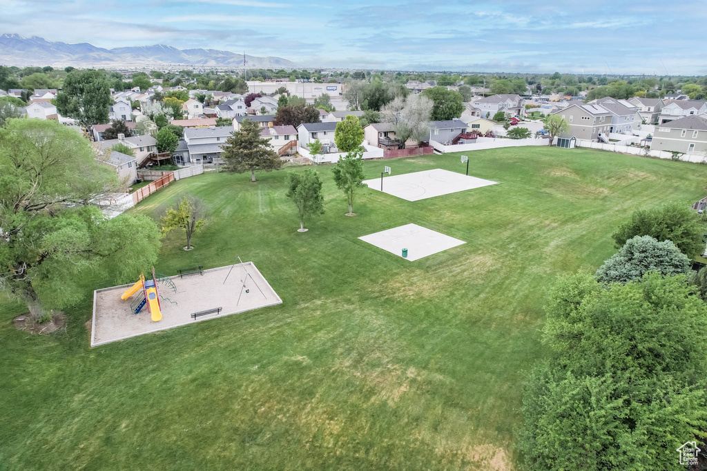 Aerial view of residential area with a mountain backdrop and a park