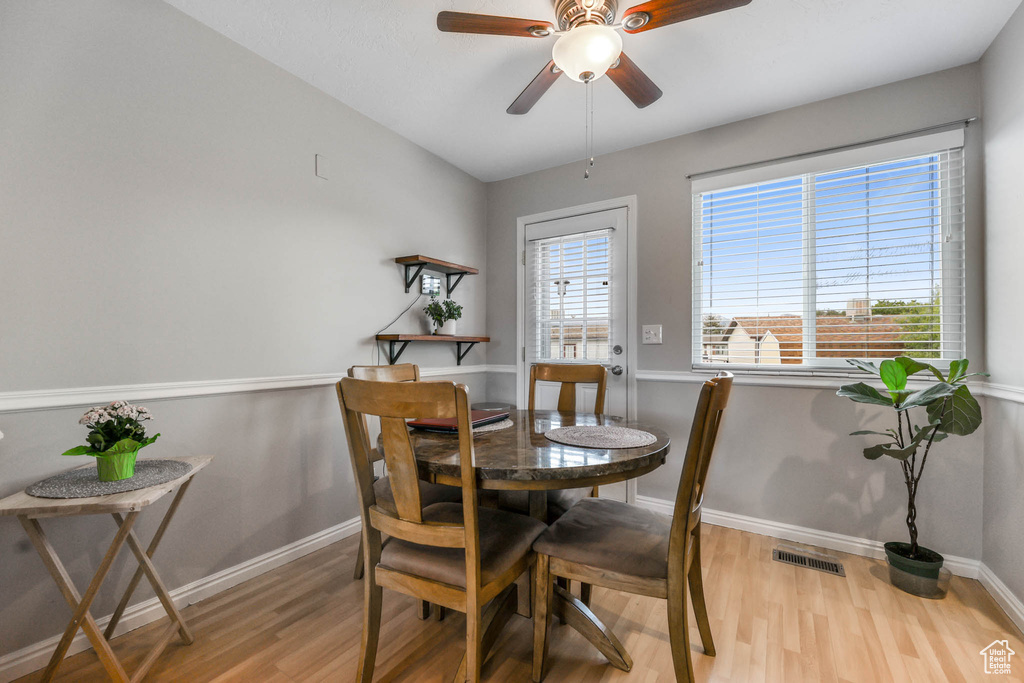 Dining space with wood finished floors, ceiling fan, and baseboards