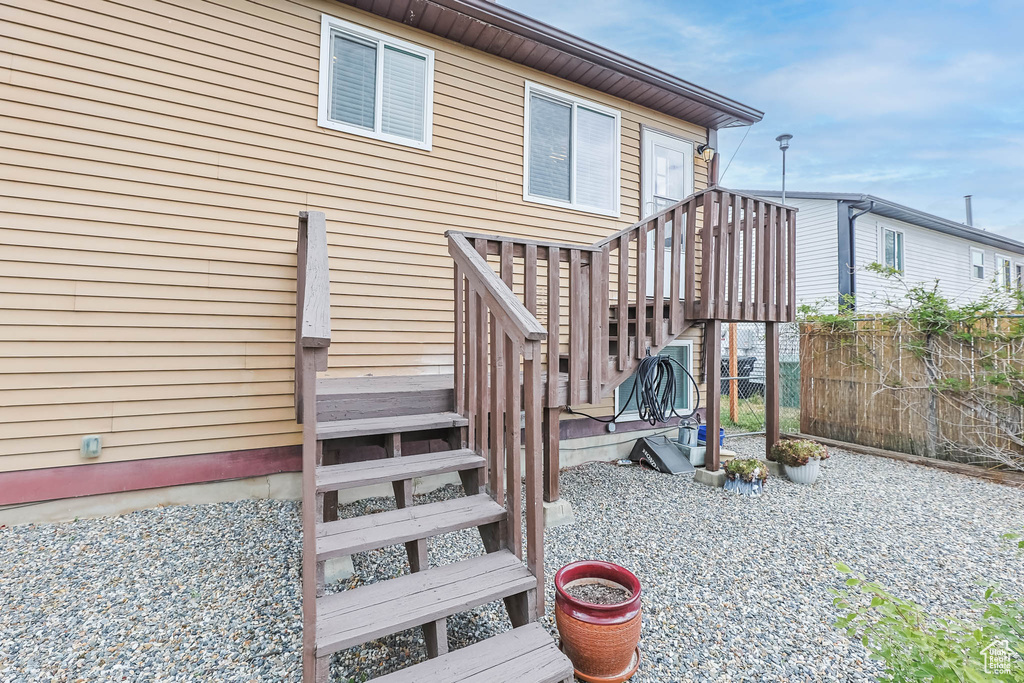 Back of house featuring fence and stairway