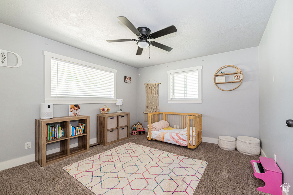 Bedroom with carpet, baseboards, and ceiling fan