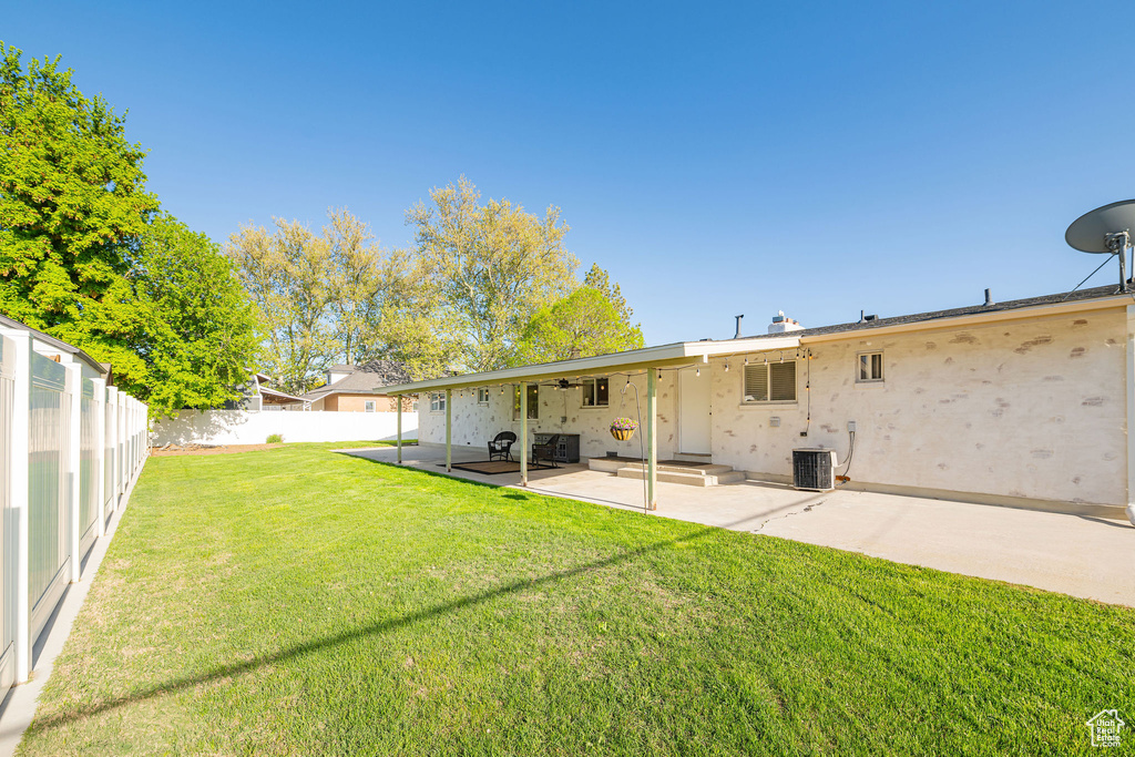 Back of house with a patio and central AC unit