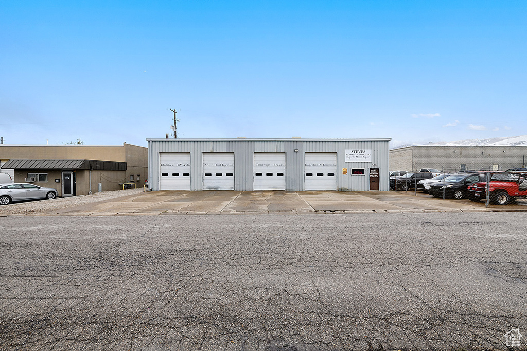 View of building exterior with a detached garage