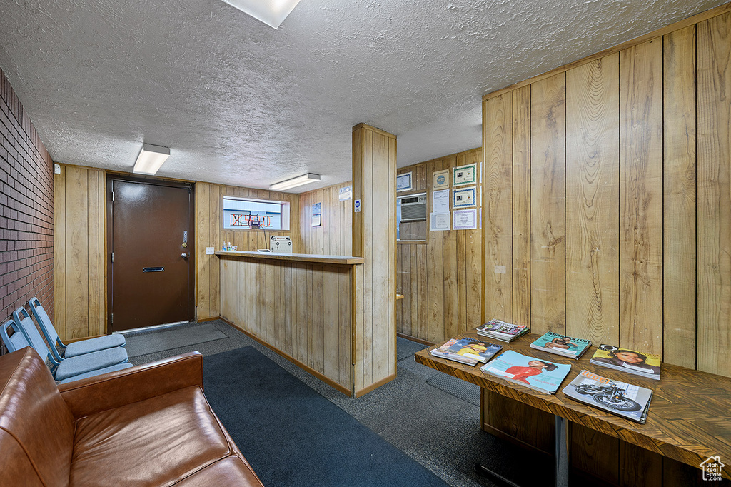 Welcome area with wood walls and a textured ceiling