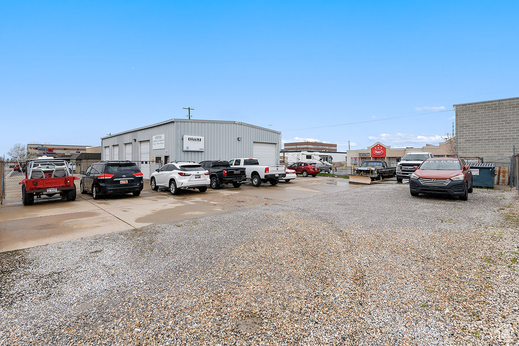 View of parking / parking lot with a garage