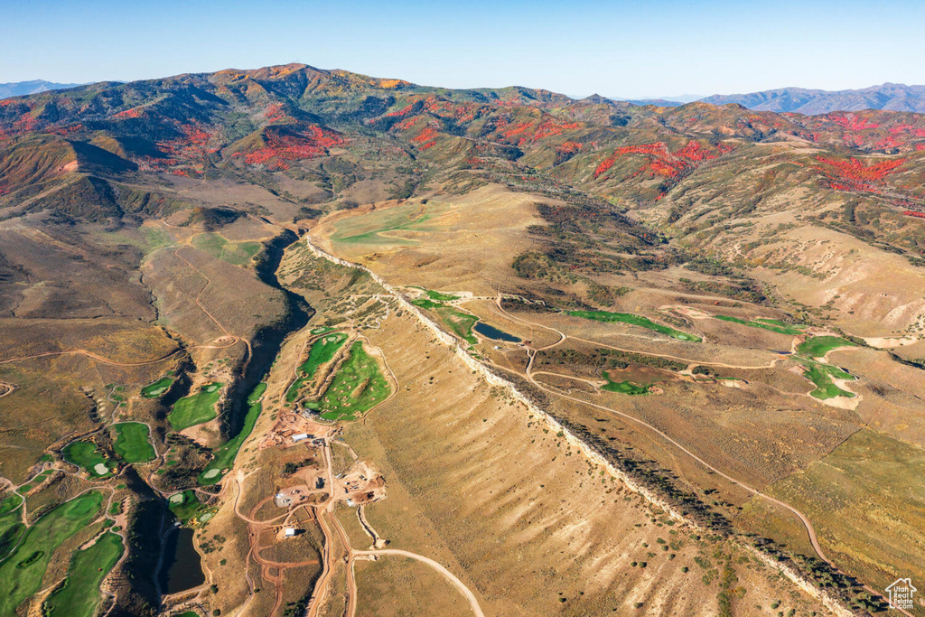 Aerial view of property's location featuring a mountainous background