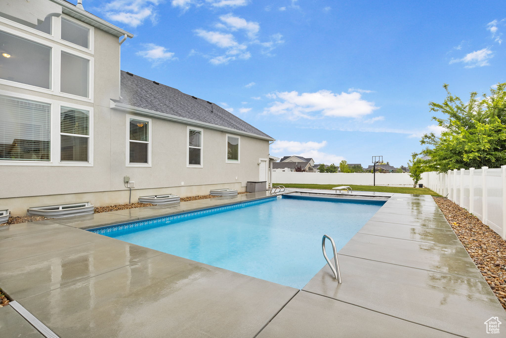 View of pool with a fenced backyard and a patio area