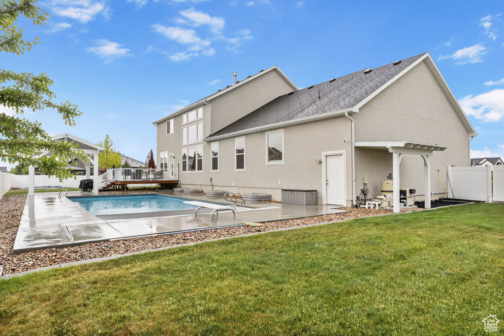 Rear view of property with a pergola, stucco siding, roof with shingles, and a patio area