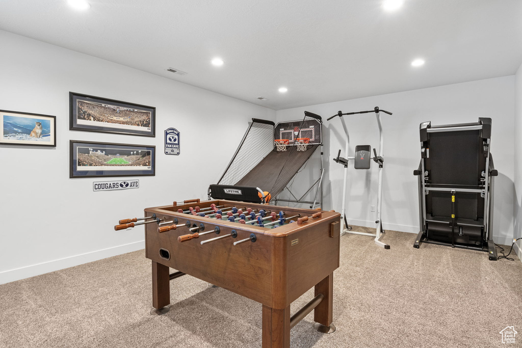 Recreation room with light colored carpet, recessed lighting, and baseboards
