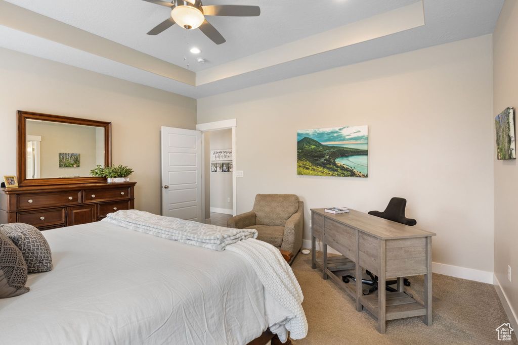 Bedroom with baseboards, a tray ceiling, carpet, a desk, and recessed lighting