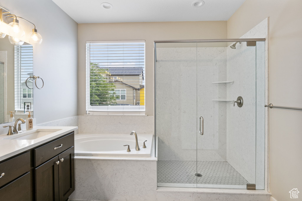 Full bath with a stall shower, vanity, a bath, and recessed lighting