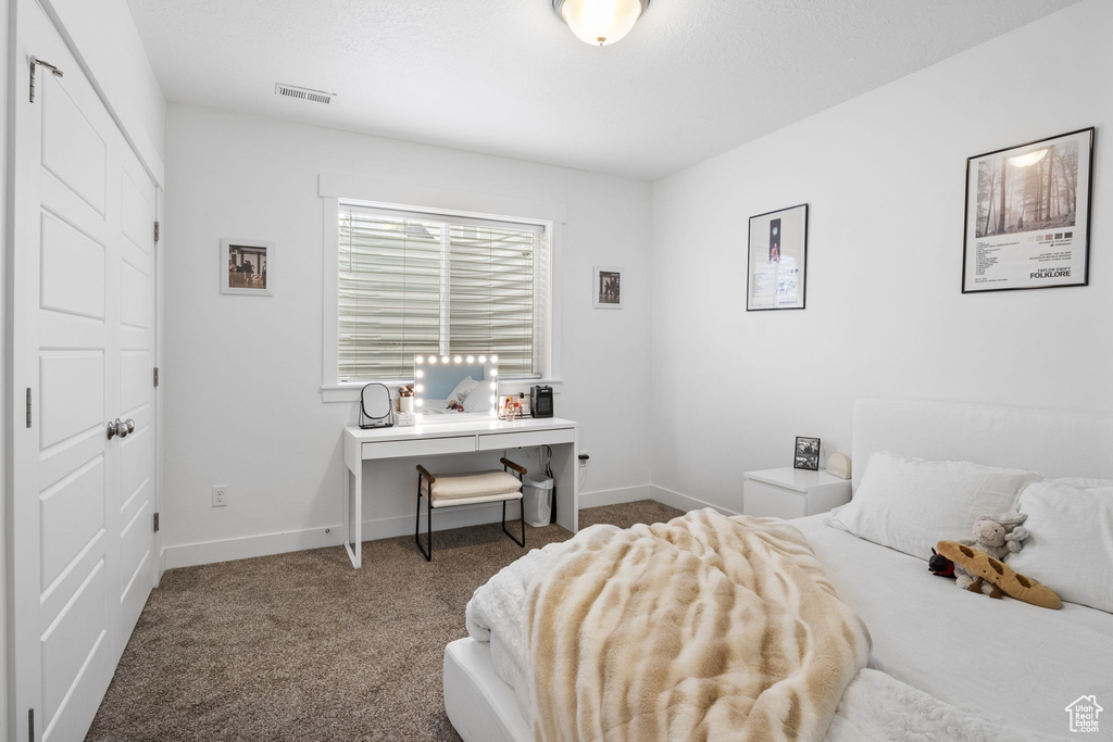 Carpeted bedroom with baseboards