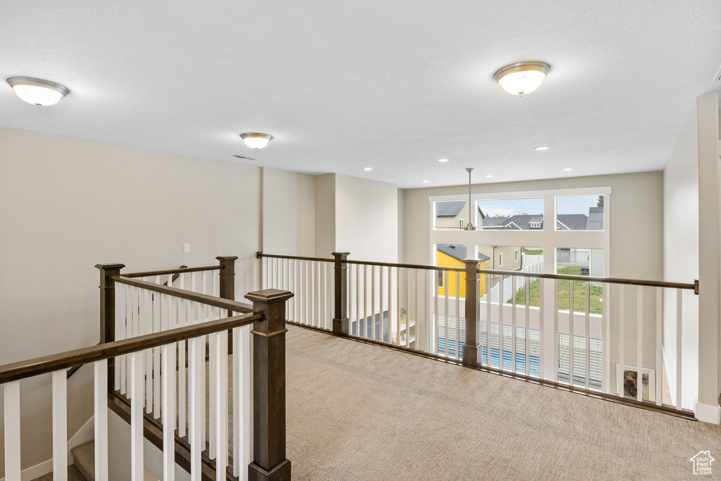 Corridor with carpet and an upstairs landing