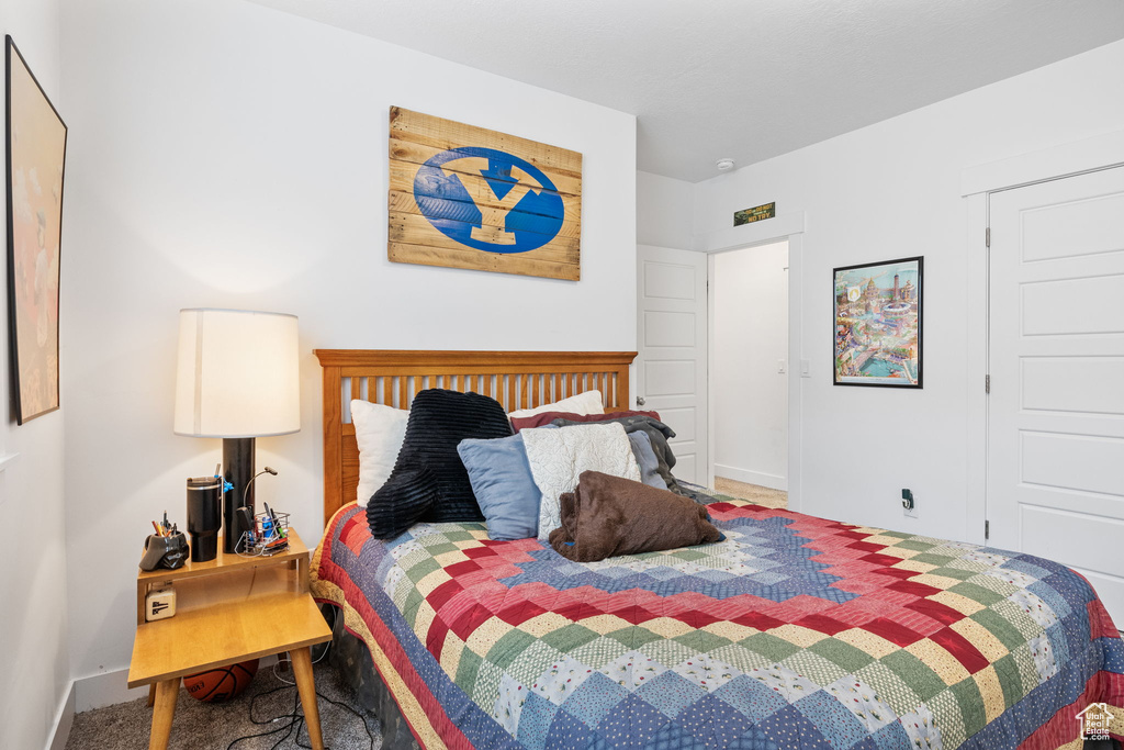 Carpeted bedroom featuring baseboards