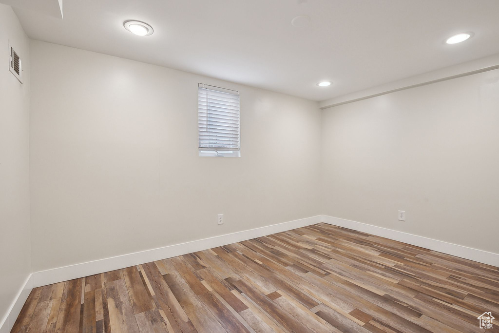 Basement with wood finished floors, recessed lighting, and baseboards