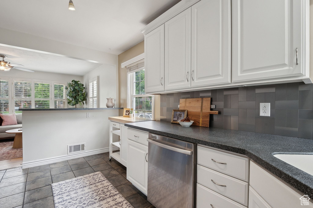 Kitchen featuring dishwasher, decorative backsplash, plenty of natural light, and a ceiling fan