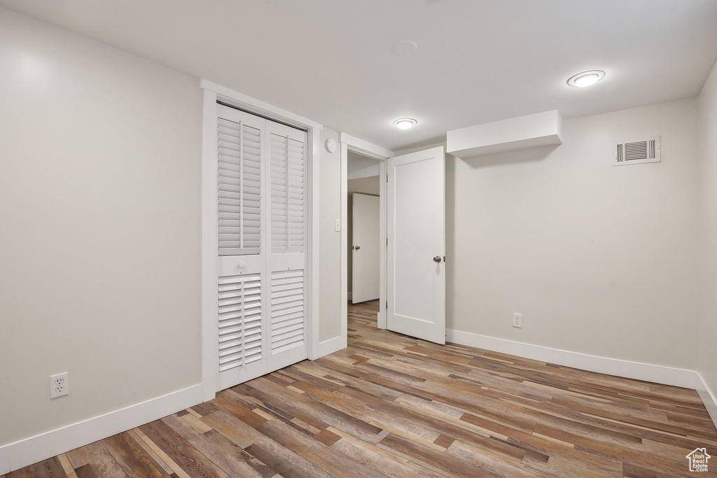 Finished basement featuring baseboards and wood finished floors