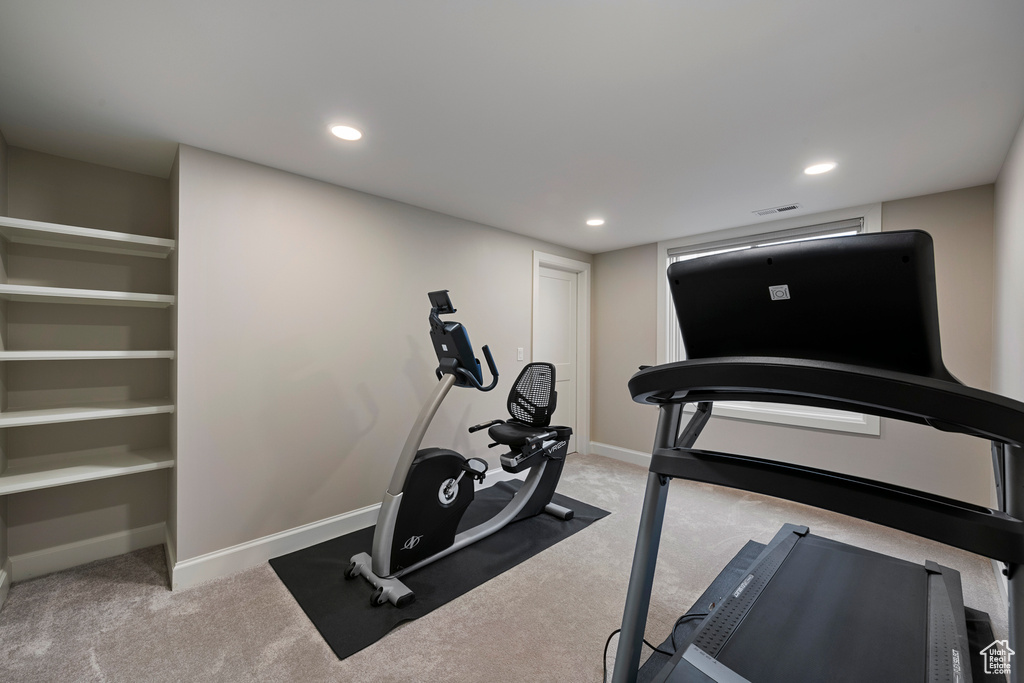 Exercise room featuring carpet, baseboards, and recessed lighting