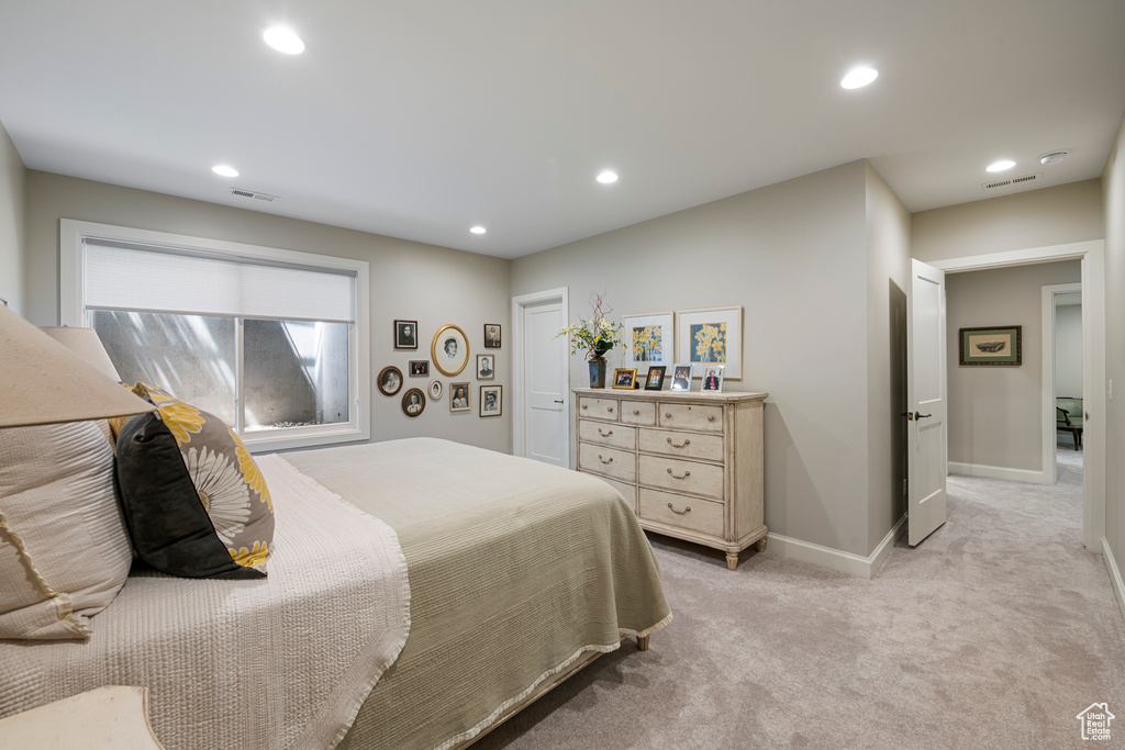 Bedroom featuring light colored carpet, recessed lighting, and baseboards