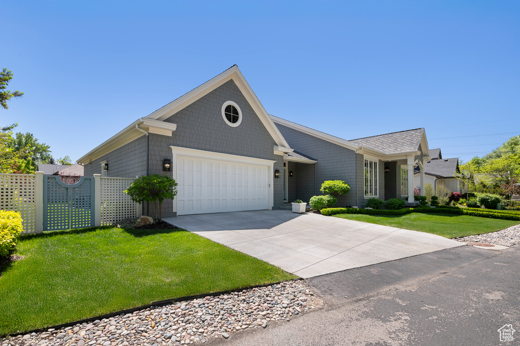 Ranch-style house featuring an attached garage and driveway