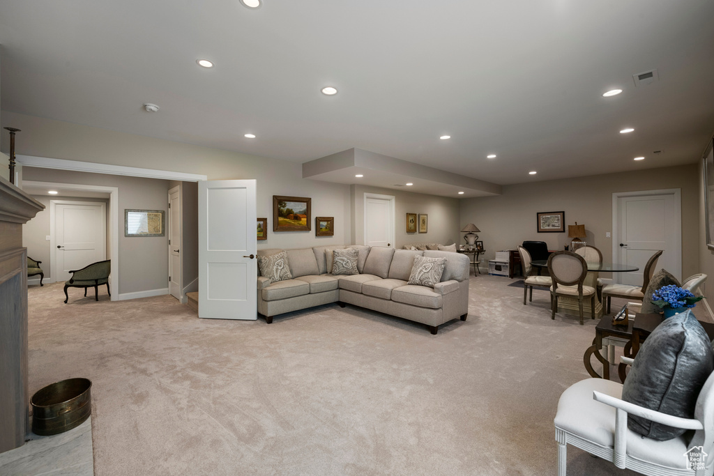 Living room featuring light colored carpet, recessed lighting, and baseboards