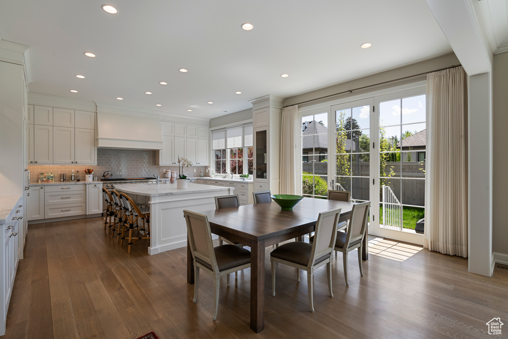 Dining area featuring dark wood finished floors and recessed lighting