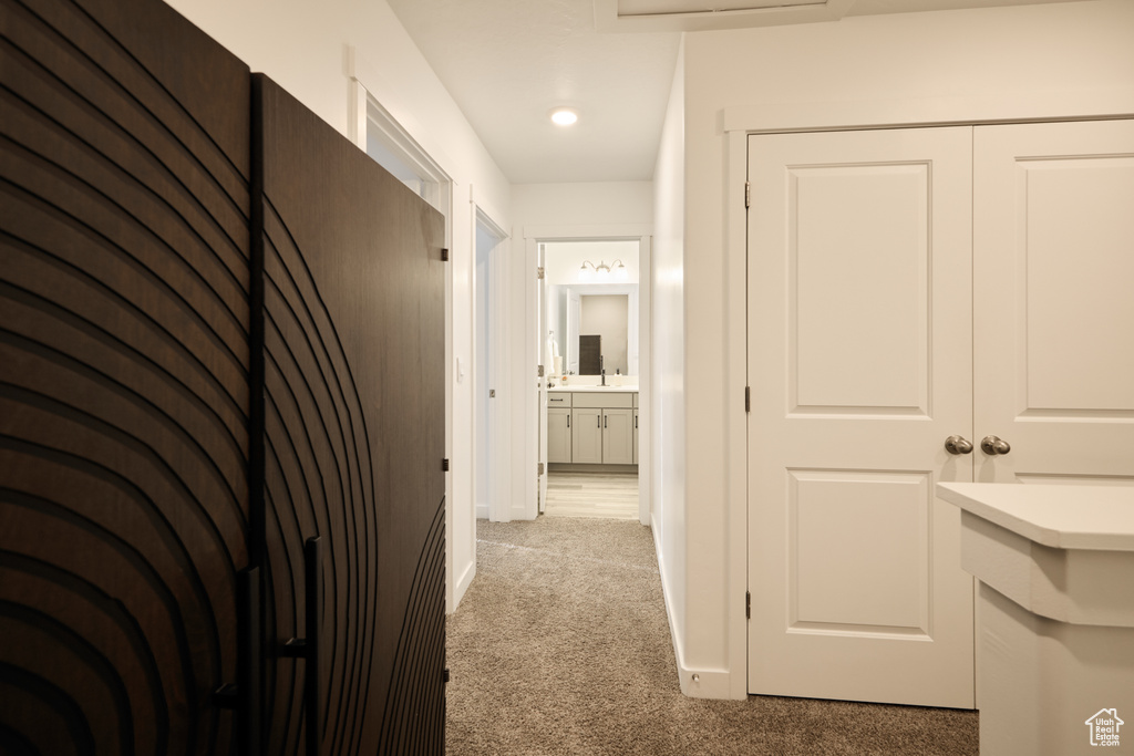 Hallway with carpet flooring and baseboards