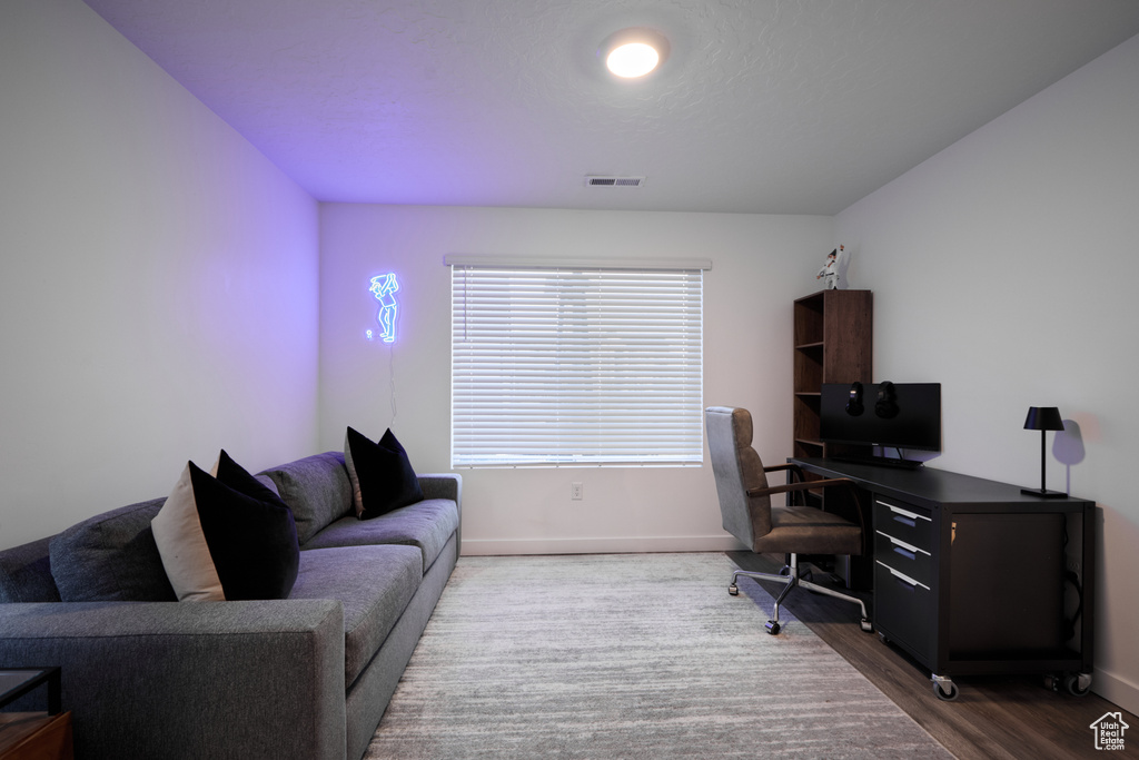 Office with baseboards and dark wood-type flooring