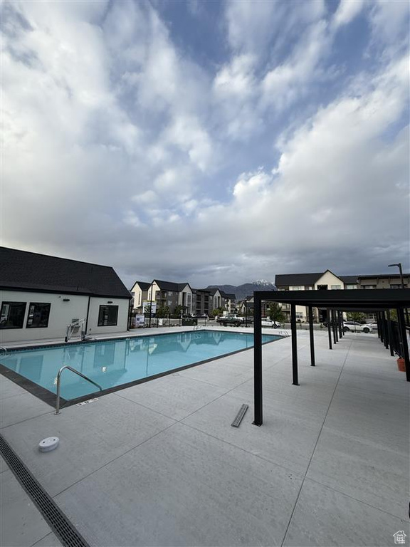 Community pool featuring a patio