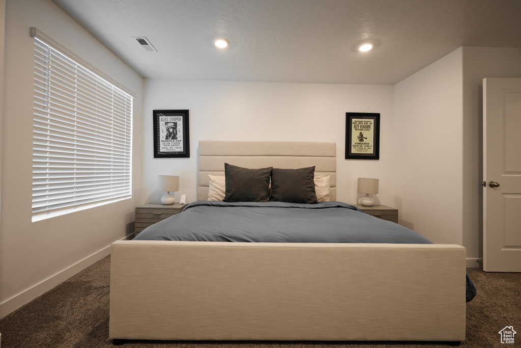 Bedroom featuring dark colored carpet, baseboards, and recessed lighting
