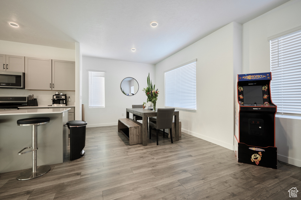 Dining area featuring light wood-type flooring, baseboards, and recessed lighting